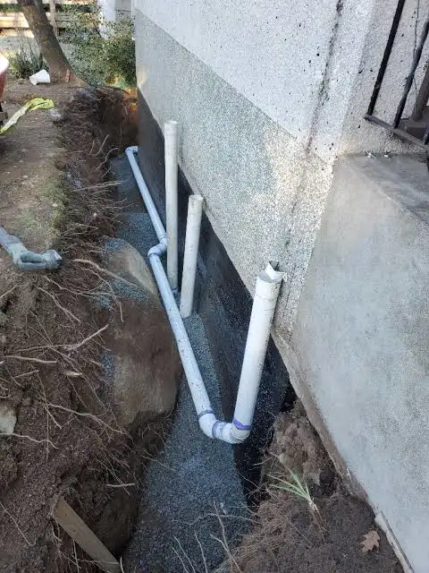 Foundation drainage pipes installed along an exterior basement wall-xtraPro